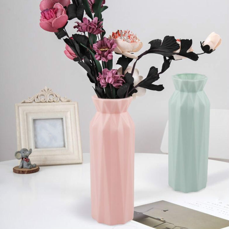 Two plastic round vases: pink and light green, faceted sides with flared rims