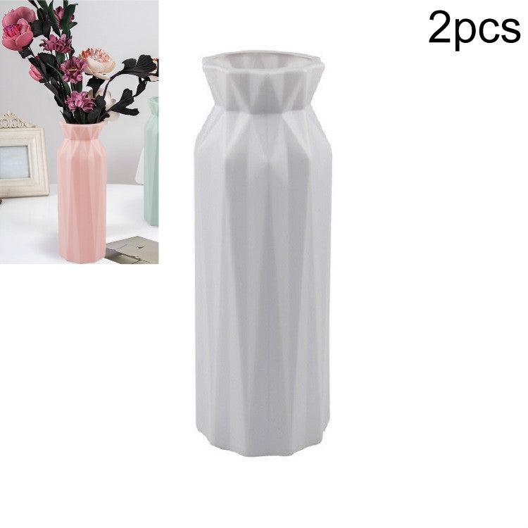 White plastic round vase with faceted sides and flared rim, tall cylinder shape