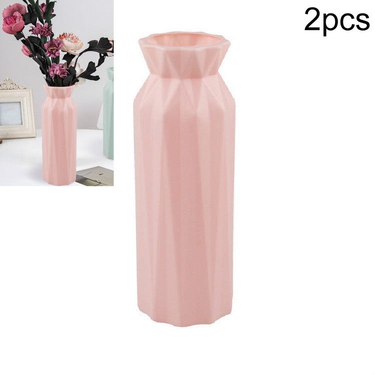 Pink plastic round vase with faceted sides and flared top opening, tall cylinder shape