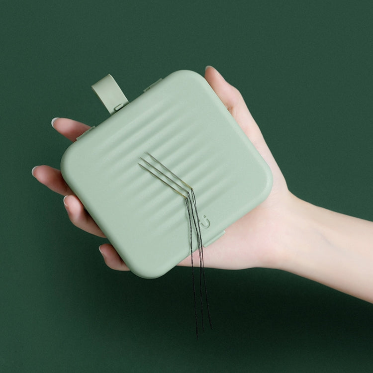Magnetic sewing storage box, mint green, held open showing needles