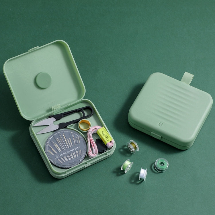 Magnetic sewing storage box, mint green, open with thread spools and tools