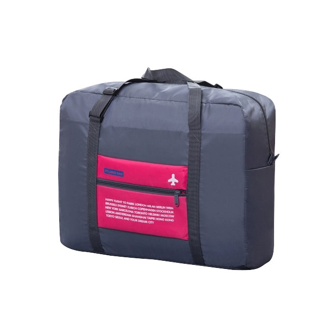 Navy folding travel bag with pink label panel and zipper closure, top handles
