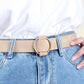 Beige wide PU leather belt with round needleless buckle on blue jeans