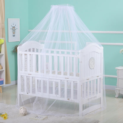 White dome mosquito net over a white crib with full canopy coverage