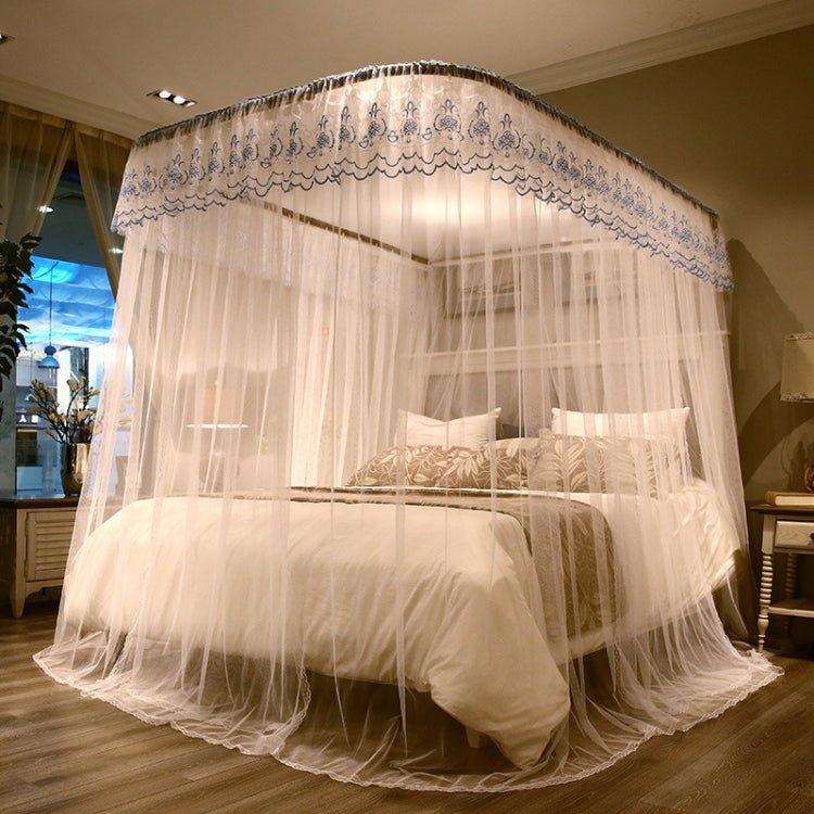White retractable three-door mosquito net with ornate border, sheer canopy over bed