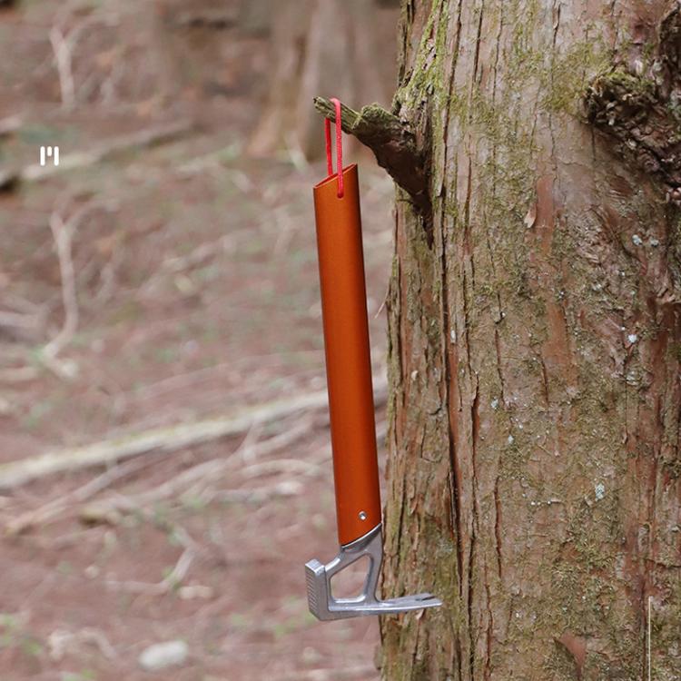 Orange tent stake mallet with claw head and red lanyard loop, against tree