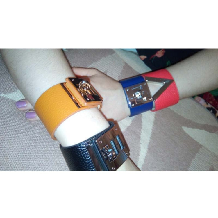 Wide leather cuff bracelet set on wrist: yellow, orange, and blue with silver buckles
