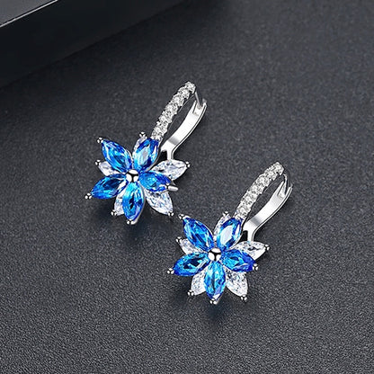 Blue flower-shaped cubic zirconia stud earrings with silver-tone prong backs
