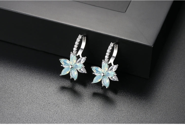 Light blue flower-shaped cubic zirconia stud earrings with silver-tone prong settings