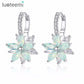 Pastel light blue flower-shaped cubic zirconia stud earrings with silver-tone hoops