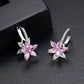 Pink flower stud earrings with clear cubic zirconia petals and hoop-like hinge backs