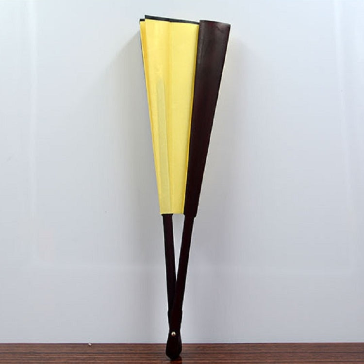Folded blank silk fan in yellow cloth with dark brown back panels and dark wooden handle.