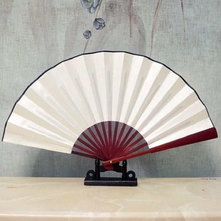 White blank silk folding fan with maroon inner ribs, Chinese-style, on black stand