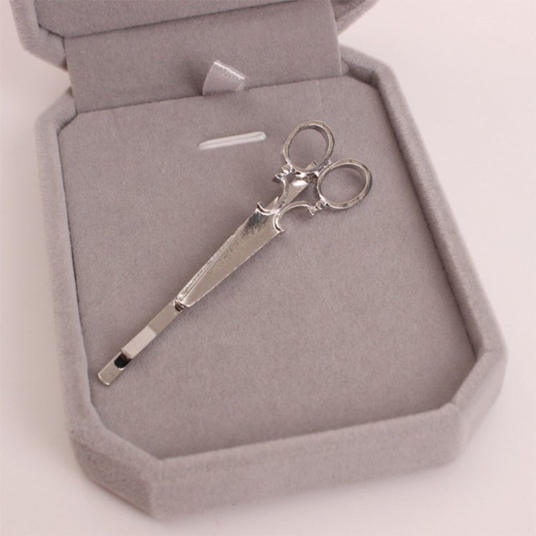 Silver hair clips set in a gray box, long bar with curled ring ornaments
