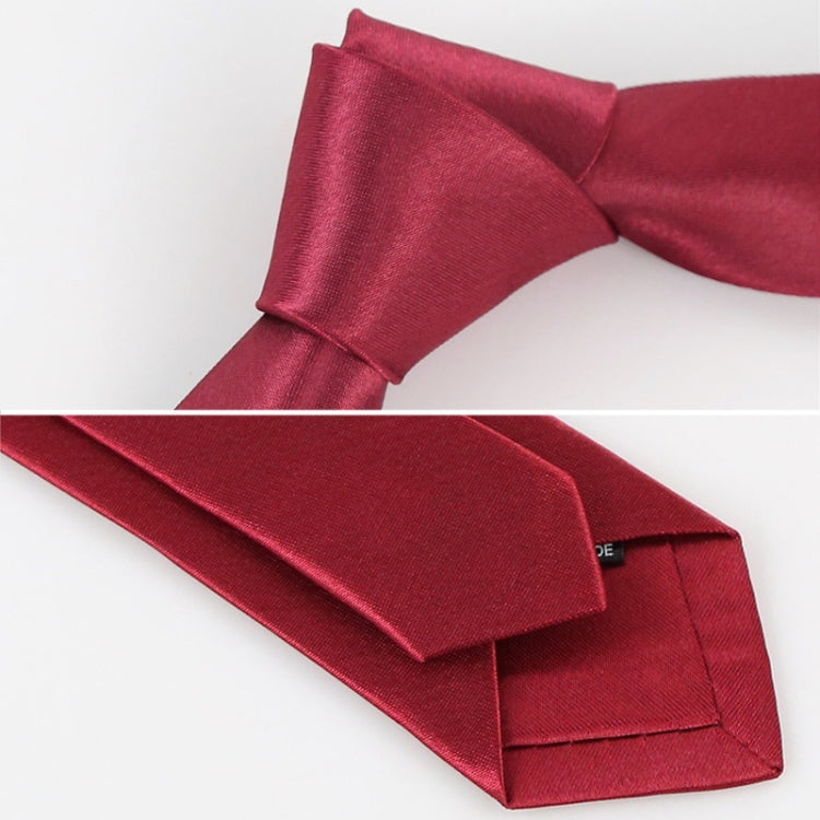 Red slim necktie with textured weave, folded close-up