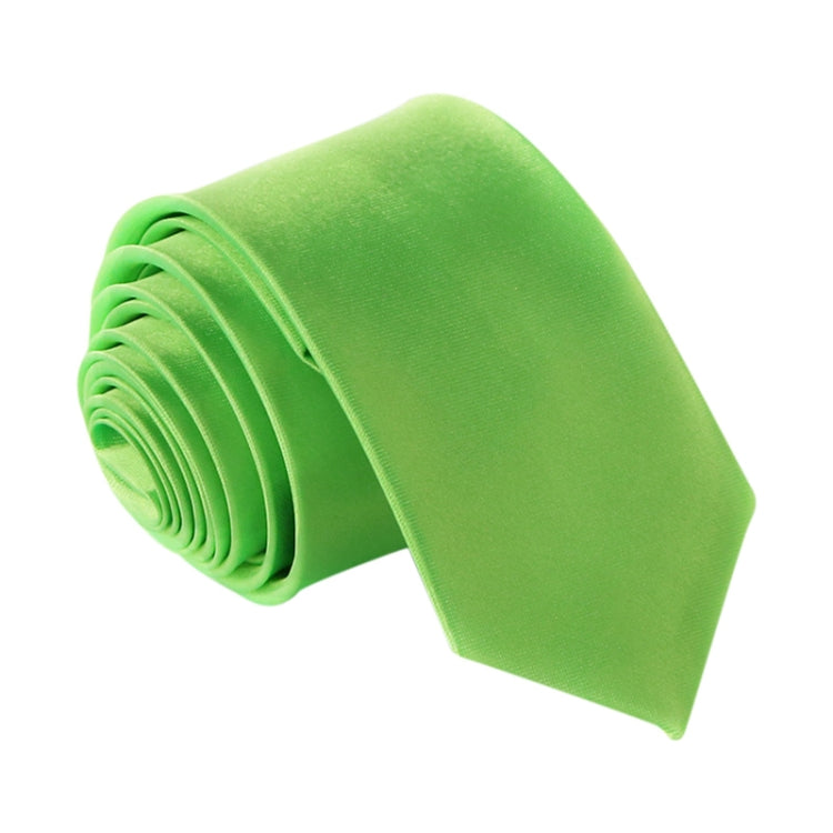 Lime green slim necktie, narrow width, rolled for display