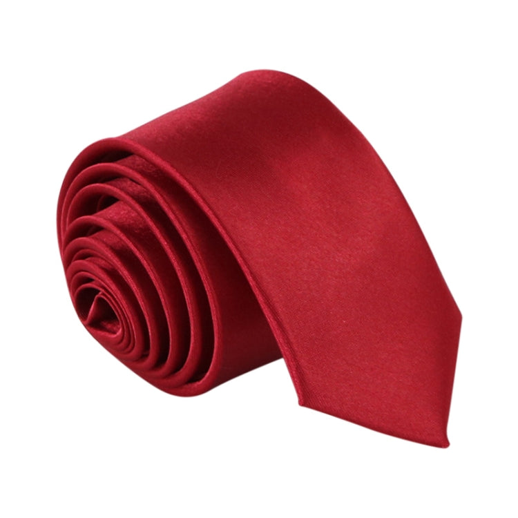 Red narrow necktie, solid color with woven texture and tightly rolled folds