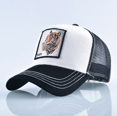 White and black trucker cap with black mesh back and embroidered tiger patch