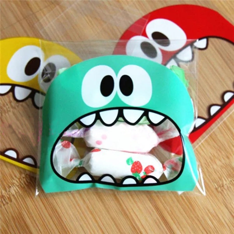 Green monster-mouth cookie gift plastic bag with printed face and visible snacks inside
