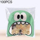 Green monster-mouth cookie gift plastic bag with printed face and pastry inside