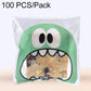 Green monster-mouth cookie gift plastic bag with printed face and pastry inside