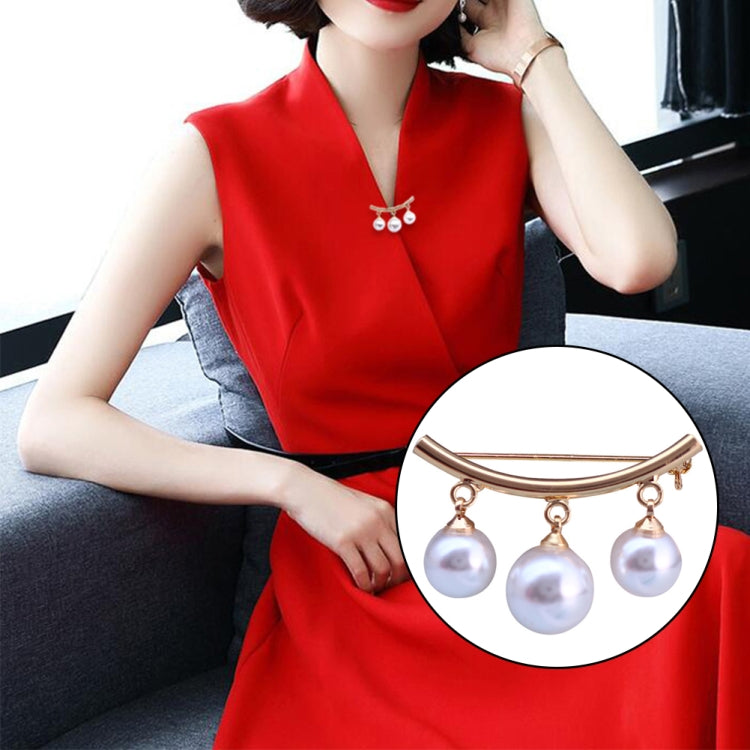 Gold-tone pearl drop brooch with curved bar and three white pearls