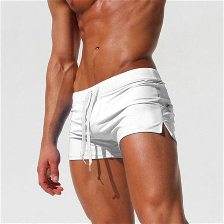 Men's white swim shorts with white drawstring and side pockets, elastic waist
