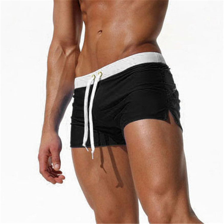 Men's black swim shorts with white drawstring and side pockets, elastic waist