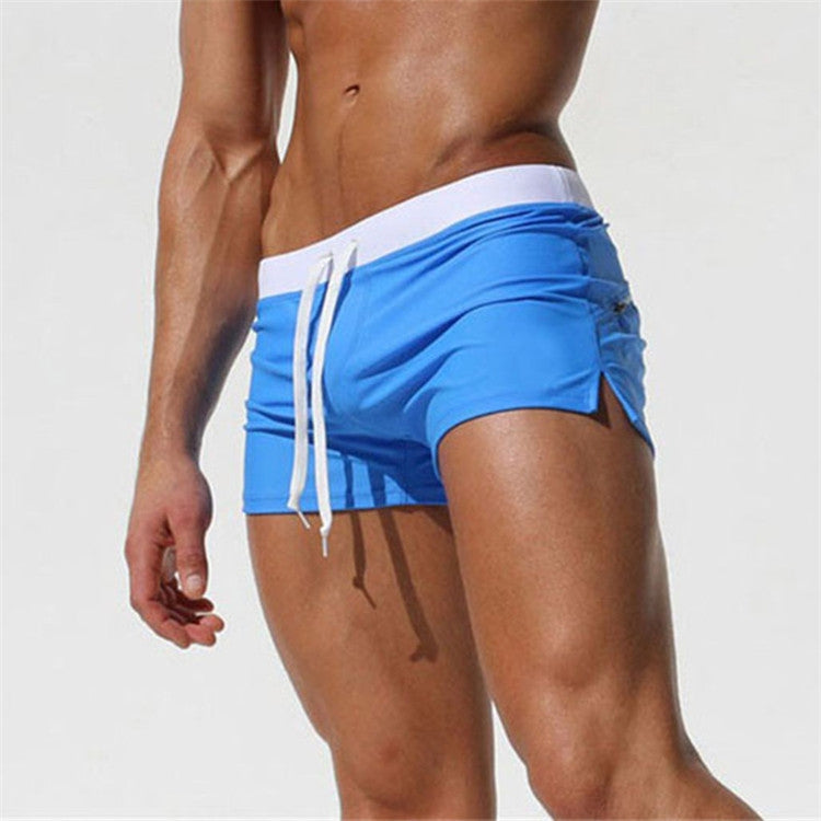 Men's royal blue swim shorts with white waistband and drawstring, side view