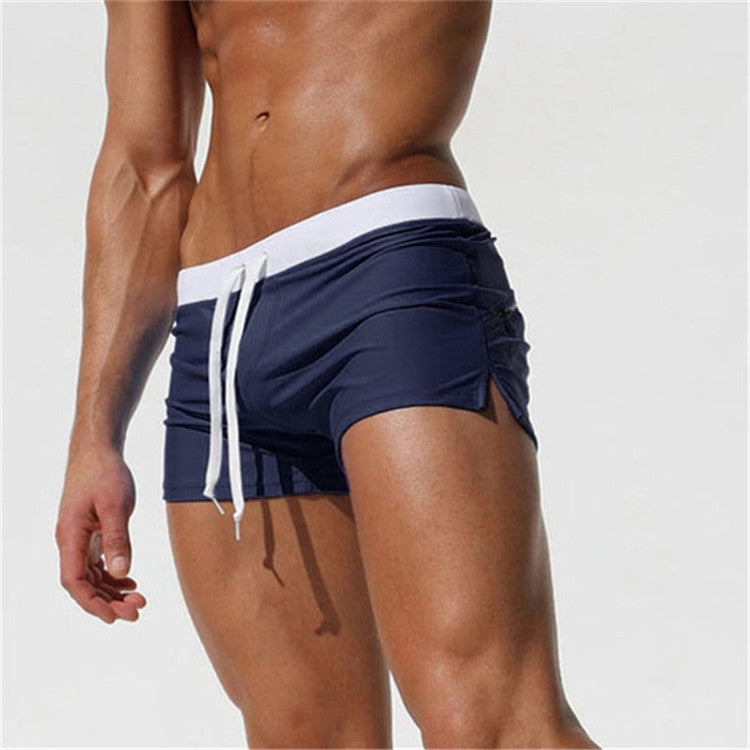 Men's navy blue swim shorts with white waistband and white drawstring, side view