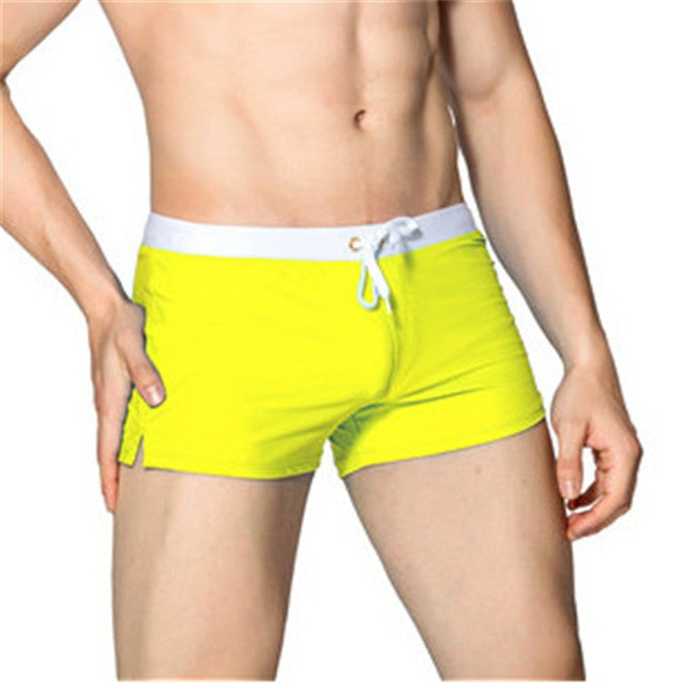 Men's yellow swim shorts with white waistband and white drawstring, front view