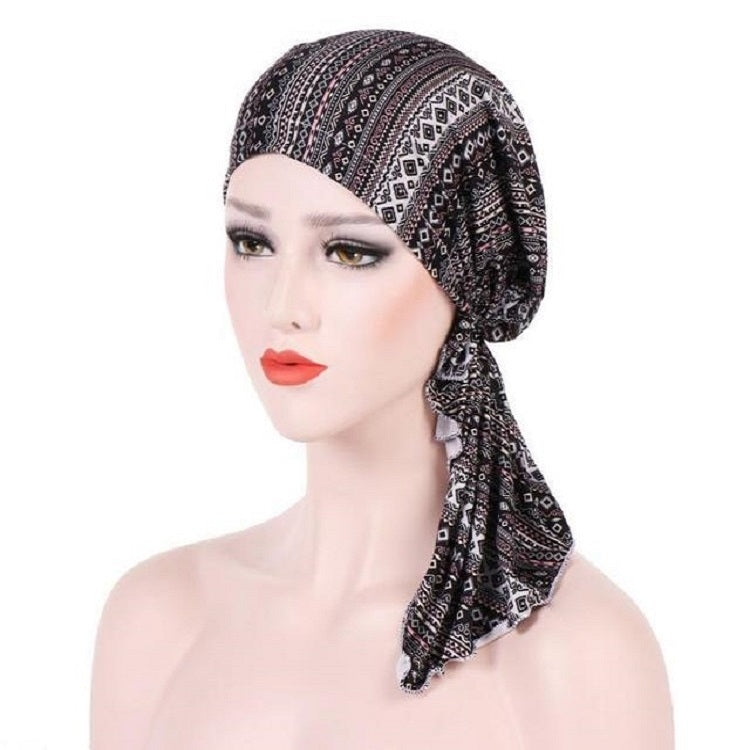 Stretch printed turban hat with long side tail, dark brown and cream geometric pattern