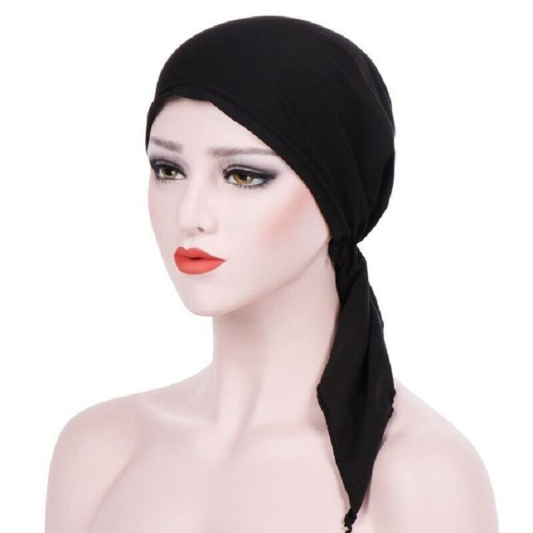 Black curved wrap cap turban hat with long side tie tail, face-framing design