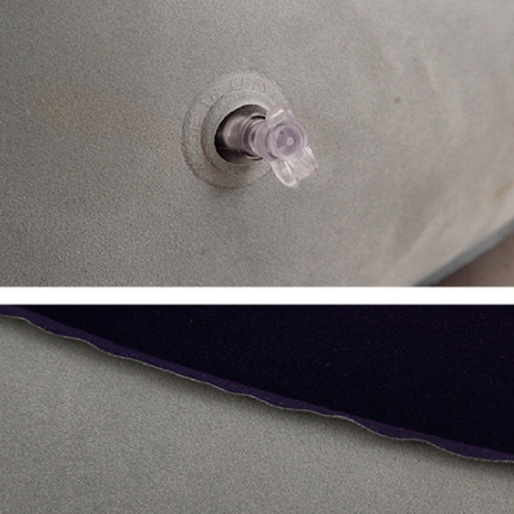 Inflatable foot rest pillow valve with clear air cap on gray fabric
