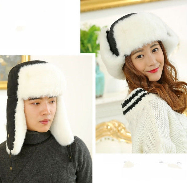 Black winter ushanka hat with white faux fur lining and triangular front logo badge