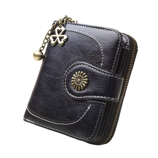 Long dark blue leather phone wallet with chain handle and zipper, front snap pocket detail