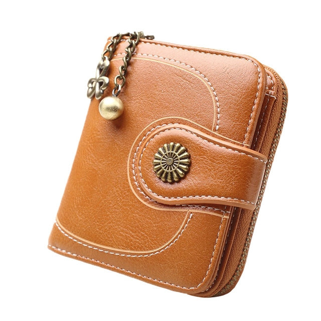 Long tan-orange leather phone wallet with wrist strap and zipper, front snap pocket detail