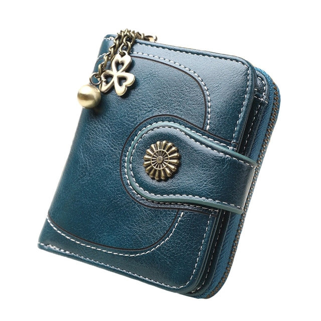 Long teal blue leather phone wallet with chain handle and zipper, front snap pocket detail