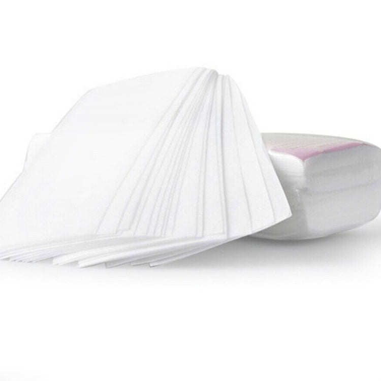 White non-woven hair removal wax paper sheets, folded and stacked, for depilation