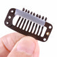 Close-up of a brown 9-tooth hair extension snap clip with metal comb and silicone back