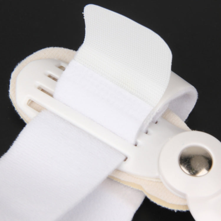 Close-up of white big toe splint hinge with round metal button and molded plate