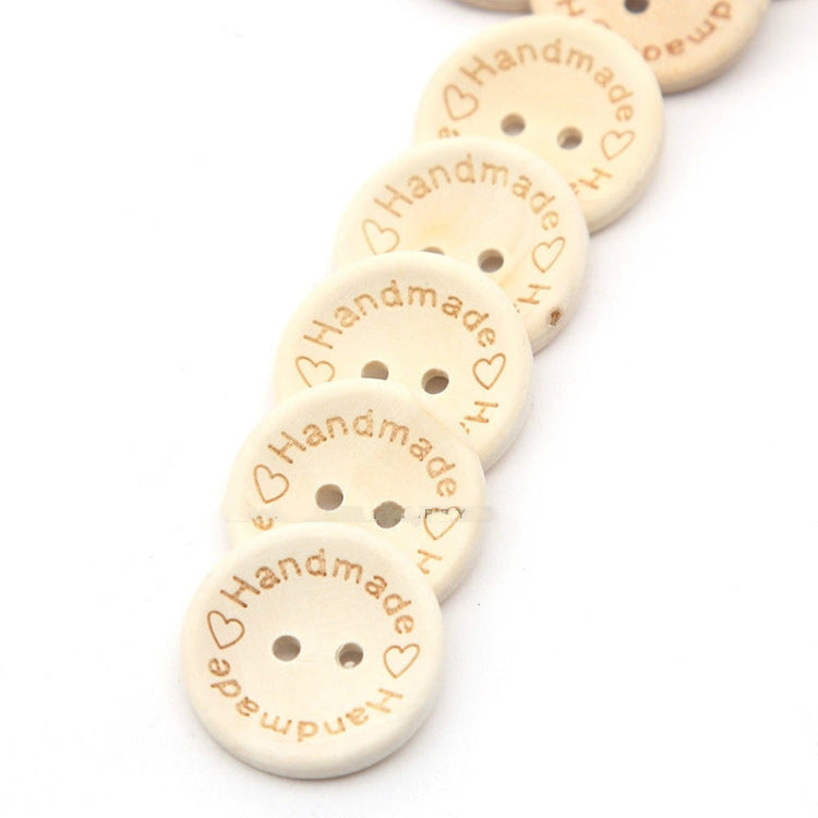 Beige wood buttons with heart and 'Handmade' engraving, each with two holes