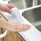 White waterproof sealing tape roll and strip, hands smoothing tape on sink rim
