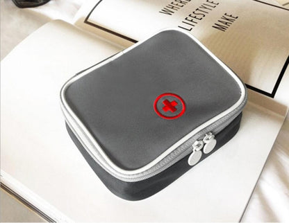 Grey mini first aid medicine bag with red heart-plus emblem and zip closure