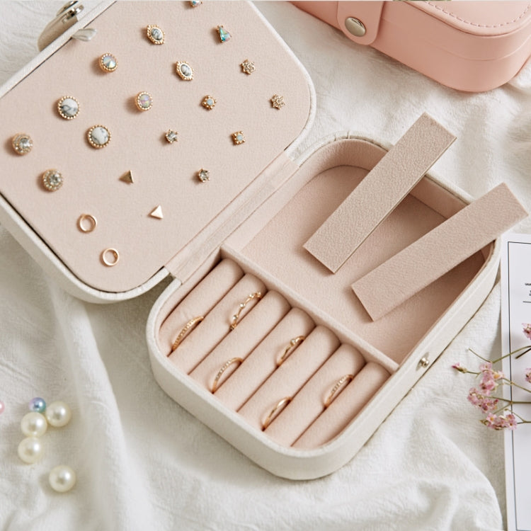Jewelry storage box open to reveal ring rows and an earring plate with compartments.