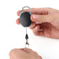 Retractable badge reel key ring clip with pull cord extended, oval black case