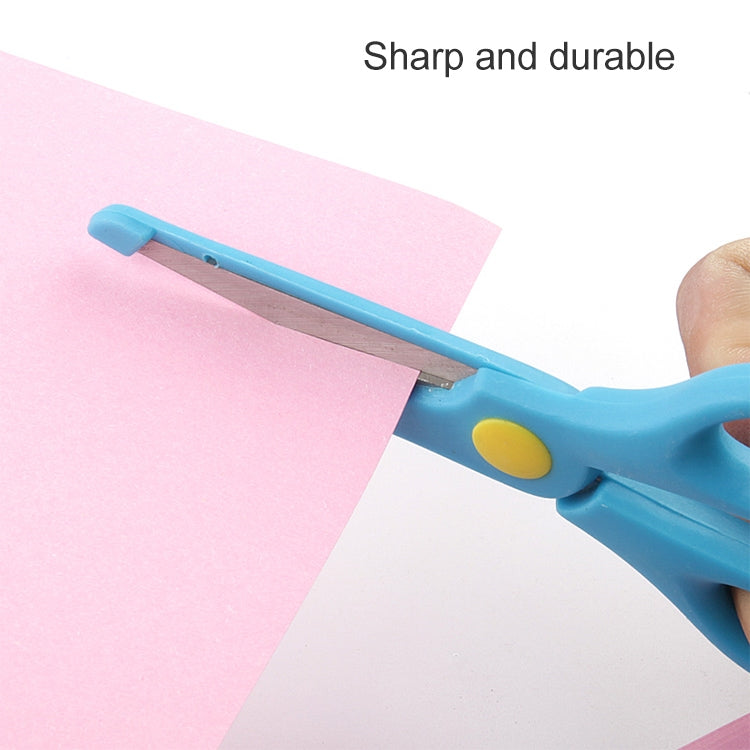Blue safety scissors cutting paper, rounded metal blade with yellow pivot