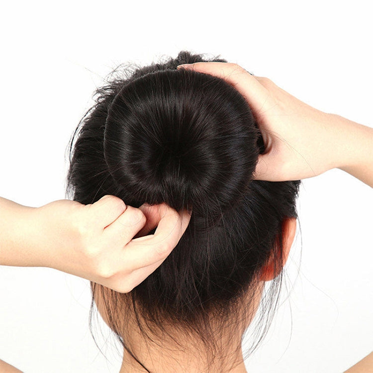 Black donut bun shaper holding a high updo