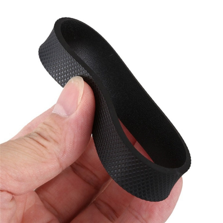Black rubber drive belt ring held in hand with textured outer surface