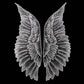 White organza wing appliques with embroidered leaf pattern on dark fabric